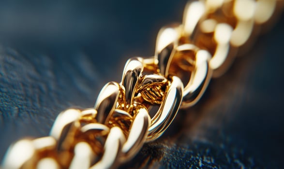A gold chain with a gold clasp photo