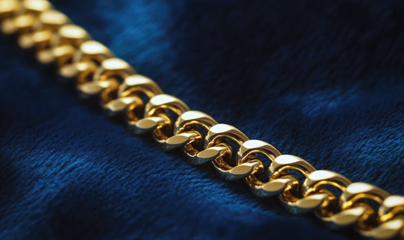 A gold chain with a blue background photo