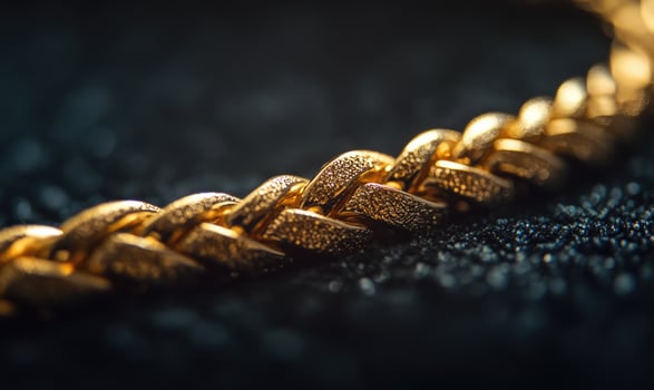 A gold chain with a black background photo