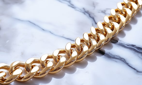 A gold chain with a silver clasp photo