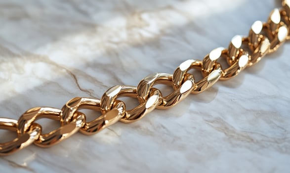 A gold chain with a silver clasp photo