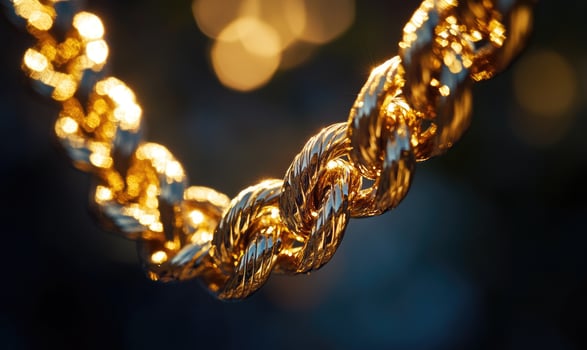 A gold chain with a knot in the middle photo
