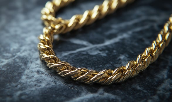A gold chain with a gold clasp photo