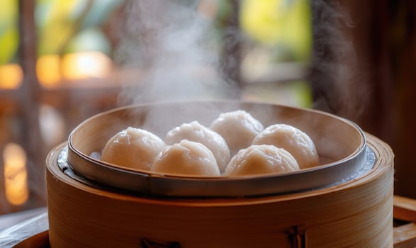 A bowl of steamed dumplings with steam rising from it photo