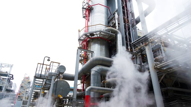 A large industrial plant with steam coming out of it photo