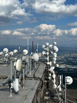Radio transmitting center with many Radio link Stations microwave is located in peak mountains, with beautiful aerial view. Telecommunications tower inspection for cell phone, radio transmitters. photo