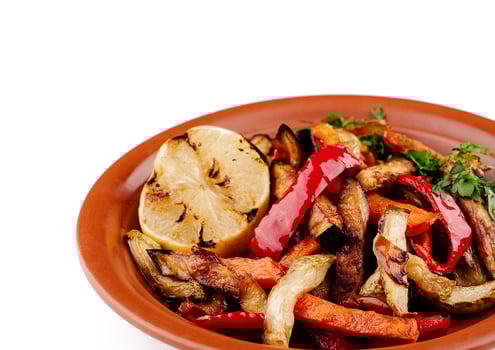 Grilled vegetables on plate with lemon, healthy vegan lunch photo