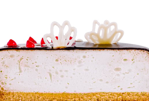 Delicious cake with white chocolate decorations is showing its layers photo