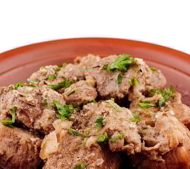 Stewed pork meat with herbs and spices on a plate photo