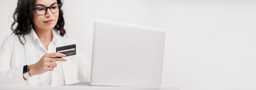 Credit Card Security. Mexican businesswoman holding credit card and entering security code using laptop photo