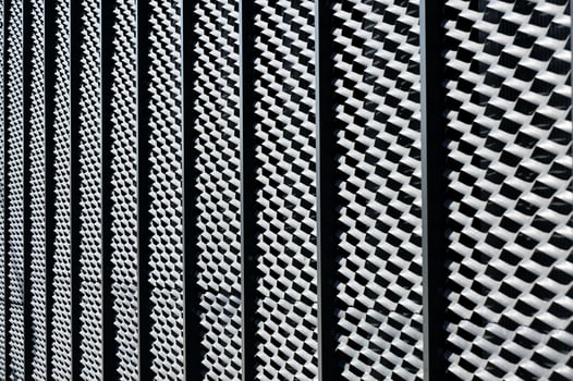 a black and white photo of a metal fence