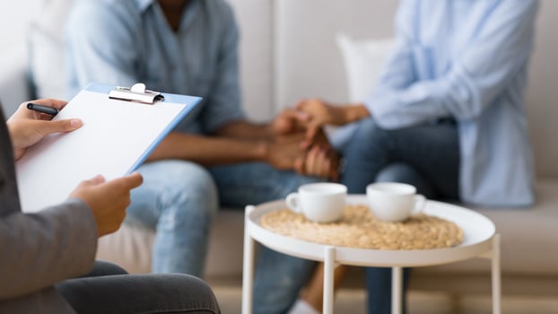 Couples Psychotherapy. Unrecognizable African American Spouses Making Up After Fight On Marital Therapy Session. Cropped, Selective Focus photo