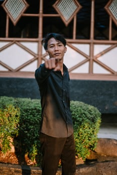 Southeast Asian man pointing with emphasis, conveying focus or direction photo