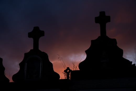 Stone crosses in a cemetery in Galicia. Silhouette in a stormy sky at dusk. photo
