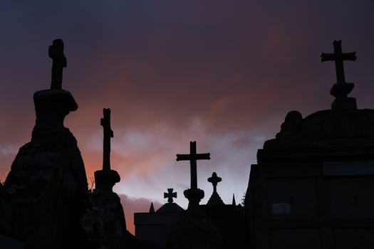 Stone crosses in a cemetery in Galicia. Silhouette in a stormy sky at dusk. photo