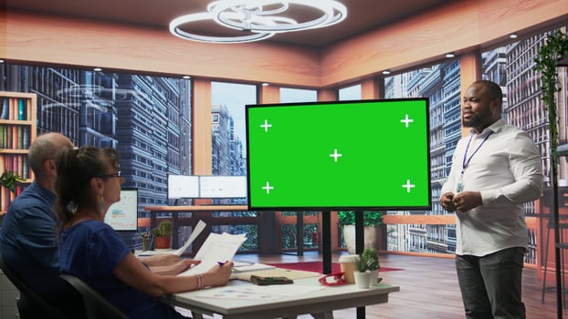 Elderly pair meeting with a financial broker next to copy space display, exploring retirement plan options and ensuring their pension for the future. Finances planning strategy. Camera B. photo