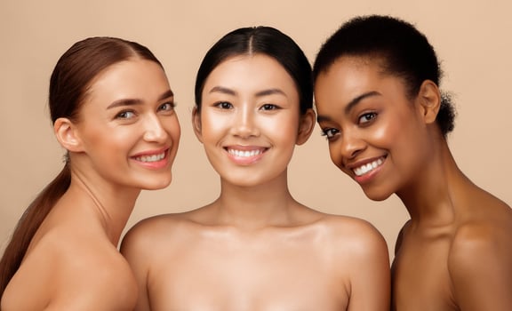 Three Gorgeous Girls Models Posing Naked Smiling To Camera Standing Over Gray Studio Background. Beauty And Body Care Concept photo