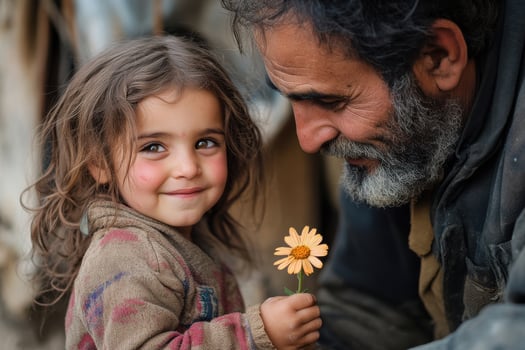 Little girl with tangled hair holds flower, father smiles at her joy photo