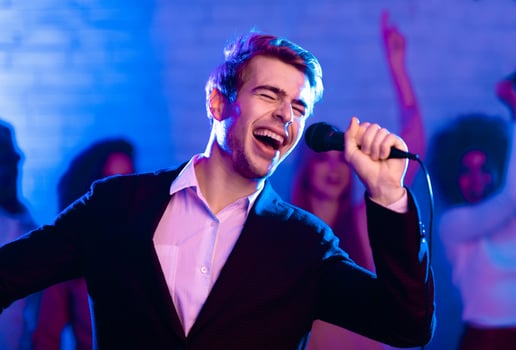 Talented Singer Guy On Karaoke Party Singing Song Having Fun In Night Club Indoor. Low Light photo
