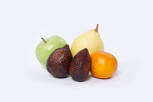 Assortment of exotic fruits isolated on white background. Close up of heap of fruit. Concept of healthy eating and dieting lifestyle. photo