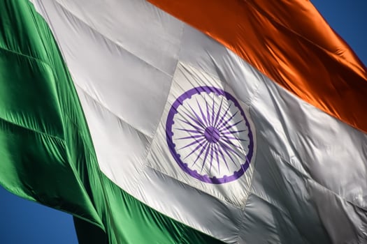 India flag flying high at Connaught Place with pride in blue sky, India flag fluttering, Indian Flag on Independence Day and Republic Day of India, tilt up shot, Waving Indian flag, Har Ghar Tiranga photo
