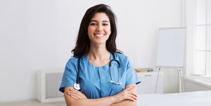 Happy Intern With Crossed Arms Looking At Camera During Conference In Meeting Room photo