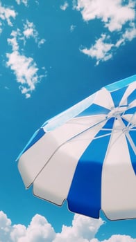 Umbrella blue and white beach for sunburn protection and blue sky bottom view photo