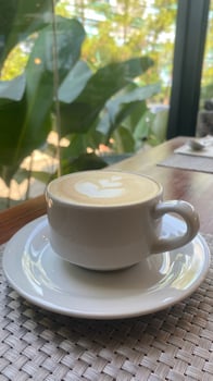 Coffee with Green Foliage Background photo