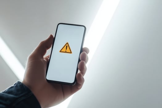 A prominent visual warning displayed on a smartphone serves to signify possible financial risks that could include issues such as fraud, market caution, and various economic challenges looming ahead photo