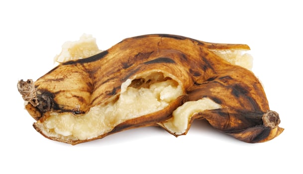 Crushed overripe banana isolated on a white background. photo