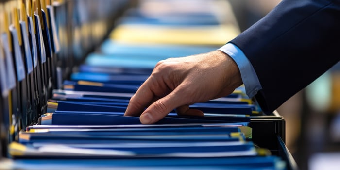 This image depicts a detailed inspection of organized audit records, emphasizing accuracy and compliance in business evaluations photo