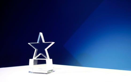 Star-shaped award on a table with spotlights and copy space photo