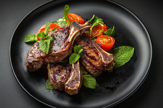 Indulge in these delicious ketogenic lamb chops that are beautifully complemented by fresh mint and a vibrant summer salad, making it the perfect choice for a healthy and satisfying meal photo