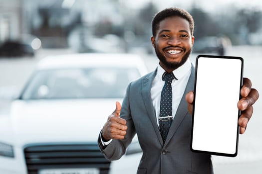 Car Rental. Happy African American Man Holding Key And Showing Thumb Up Near Automobile photo