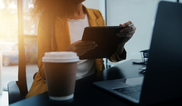 Close up Business woman using calculator and laptop for do math finance on wooden desk, tax, accounting, statistics and analytical research concept photo