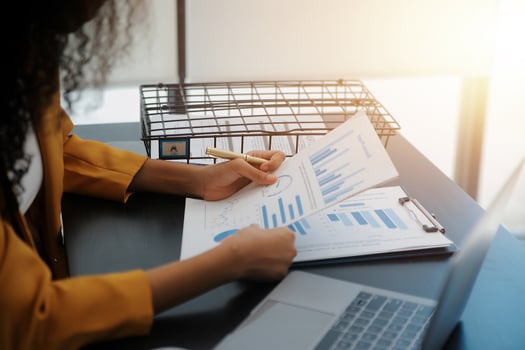 Close up Business woman using calculator and laptop for do math finance on wooden desk, tax, accounting, statistics and analytical research concept photo