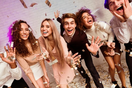 Cool Party. Millennial Friends Enjoying New Year Celebration Dancing Under Falling Confetti Having Fun Indoors. photo