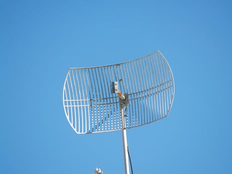 Crude Looking Metal Antenna In Clear Blue Sky photo