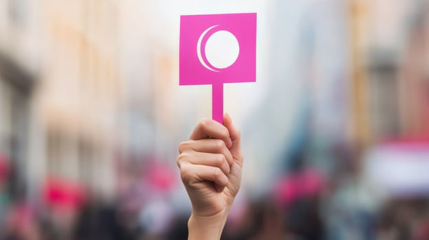 Woman Holding Pink Protest Sign at Feminist Rally in City Street Advocating for Gender and Social Justice photo
