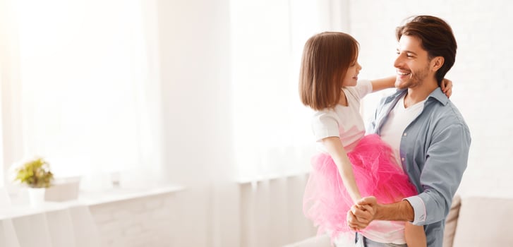 Loving father and little princess daughter dancing waltz at home, dad holding girl photo
