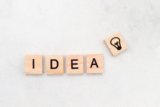 Top view of Idea word on wooden cube letter block on white background. Business concept photo