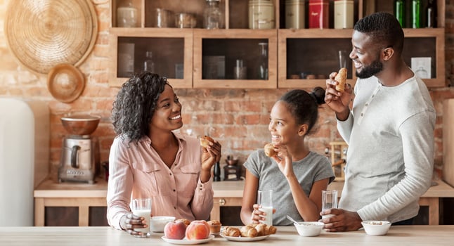 Friendly african american family having conversation during breakfast at kitchen, happy cozy atmosphere, copy space photo