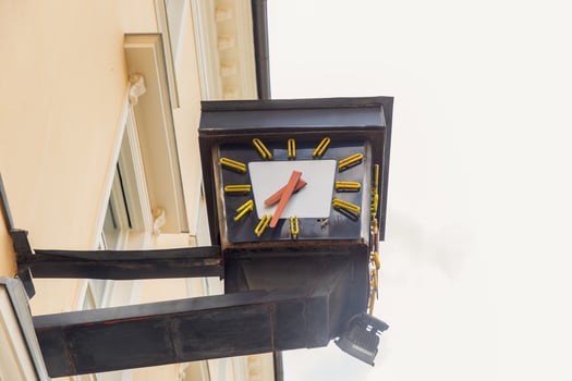 Vintage clock against building facade, urban architecture, timekeeping element, street view, outdoor, city life concept photo