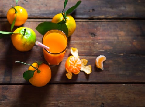 Glass of fresh tangerine juice with ripe tangerines photo
