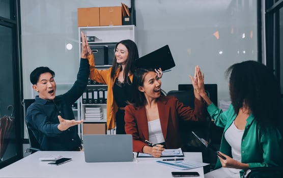 Young corporate employees sitting in office looking at laptop screen reading good news excited happy team diverse people celebrating victory win command success excellent result professional teamwork photo