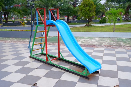blue slide with iron stairs for children to play in the park photo
