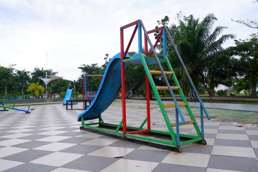 blue slide with iron stairs for children to play in the park photo