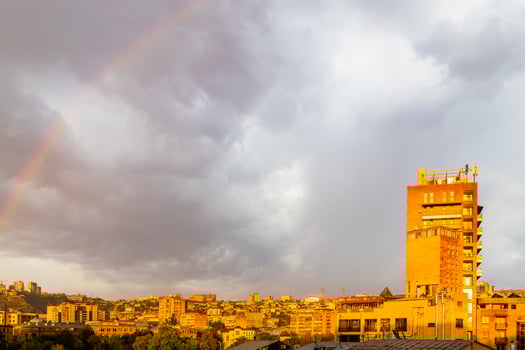 rainbow in gray cloudy sky over Yerevan city photo