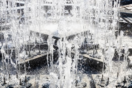 water jets of fountain closeup on sunny summer day photo
