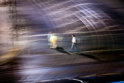 Panning Shot of Pedestrians Crossing a Road in Berlin at Night photo